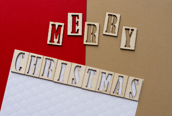 the expression "merry christmas" in wood stencil font