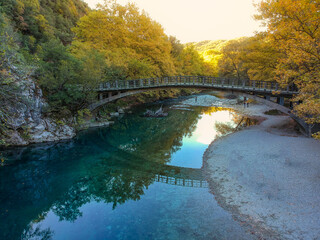 Scenic view over the natural beauty at the famous voidomatis river passing from the National park of Vikos and a beautiful bridge near Aristi village in Autumn. Epirus, Greece, Europe