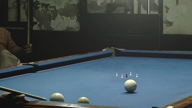 Elderly Men playing Five-pin Billiards in a Bar in Buenos Aires, Argentina.  