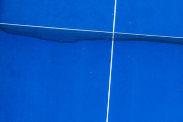 Net on a blue paddle tennis court, aerial view. Healthy sport concept.