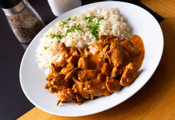 Tasty beef stroganoff with rice and parsley. Czech cuisine