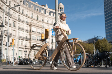 Plakat Woman with bike strolling in daytime