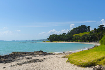 Fototapeta na wymiar Panoramic View of Waiomanu Beach, Maraetai Beach Auckland, New Zealand; Rocky Parts of the Beach during Low Tide