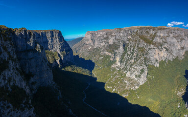 Aerial panoramic view of the impressive Vikos gorge in the Zagoria region at Pindus Mountains of northern Greece. It lies on the southern slopes of Mount Tymfi and it is the the deepest in Europe.