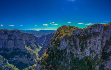 Aerial panoramic view of the impressive Vikos gorge in the Zagoria region at Pindus Mountains of northern Greece. It lies on the southern slopes of Mount Tymfi and it is the the deepest in Europe.