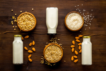 Variety of non dairy vegan milk with ingredients - almonds soy rice and oats