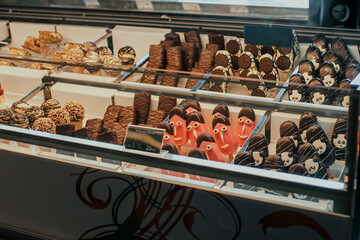 Big display showcase with lots of delicious sweets and ice cream on sticks