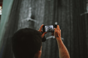 Person holding phone by taking pictures and videos on the modern smartphone camera 