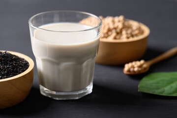 Soy milk with black sesame on black background, Healthy drink