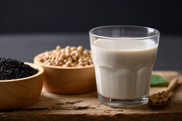 Soy milk and black sesame on wooden with black background, Healthy drink