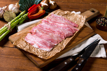 Raw meat decorated with ingredients