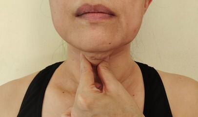 portrait of a woman squeezing under the neck, wrinkle on the face.