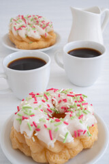 French Cruller Pastry Served with Coffee on White Wooden Table with Copy Space