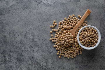 Soybean raw food nutrition in wooden spoon on a pile