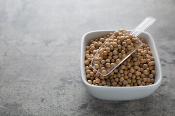 Soybean raw food nutrition in spoon on a bowl