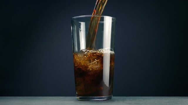 Ice Cubes And Coke Poured Into Glass