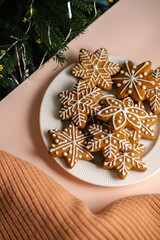 Ginger Christmas cookies on the on a delicate peach background.