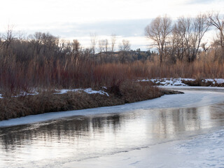 Fototapeta na wymiar Ice and Snow on a Bend of the Little Bighorn River near Wyola, Montana, at Dawn