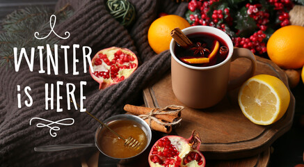 Cup of tasty mulled wine on table. Hello winter