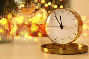 Fototapeta na wymiar Golden clock on table on New Year eve
