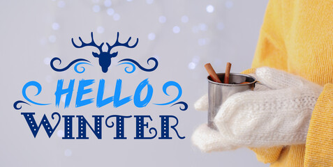 Woman with tasty mulled wine on light background. Hello winter