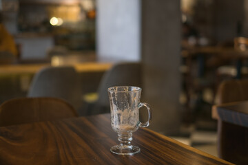 Empty latte glass cup on the table in coffee shop. High quality photo