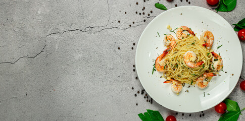 Tasty homemade spaghetti with shrimp olive oil and basil. This is healthy Italian food presenting from above.