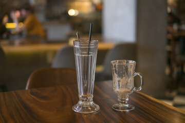 Two empty iced coffee glass cups on the table in coffee shop. High quality photo