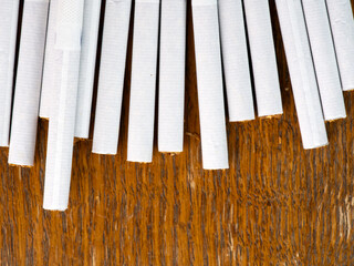 Lots of cigarettes on a wooden background top view. Closeup