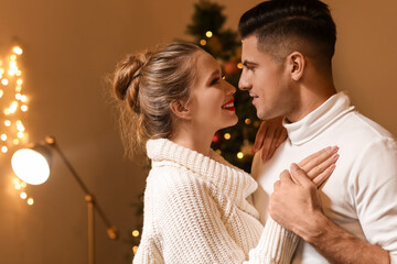 Happy young couple having romantic date on Christmas eve