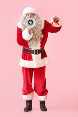 Santa Claus with megaphone and Christmas bell on pink background