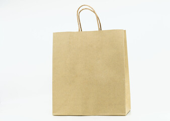 Isolated brown paper bag on white background, brown paper bag with paper handle, blank space on the front for design elements.