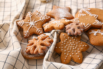 Tasty gingerbread cookies on checkered napkin, closeup