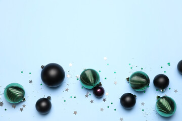 Beautiful Christmas balls and confetti on blue background