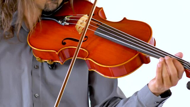 Close up of long hair ethnic musician in grey button up shirt playing red viola against white backdrop