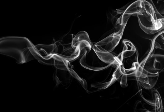 Smoke the white incense on a black background for design. darkness concept