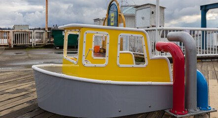 Outdoor playground for children with ships. Small ships or boats for children in a playground in a city.