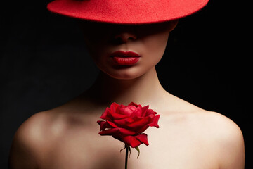 Fototapeta premium Beautiful young Woman In Red Hat and Flower