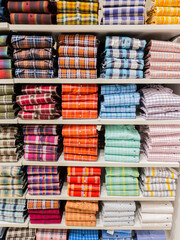 Stacks of colorful checks pattern full sleeves shirts displayed on the shelf of a retail shop in Pune Insia on 9 December 2021 