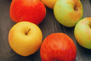 Fototapeta na wymiar Beautiful multi-colored apples on the table