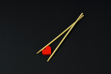 Valentine's Day card. Chopsticks, red hearts. Love, loveless black background. Lovers, Heartbreakers - obrazy, fototapety, plakaty