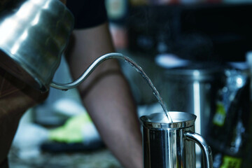 Close up of coffee pot pouring hot water - Powered by Adobe