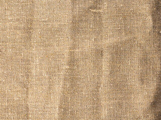 rough fabric background made of brown textured burlap