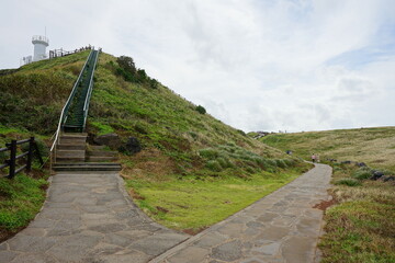 a lighthouse and a seaside walkway