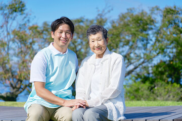 Obraz premium 介護士と高齢者 屋外