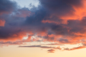 Beautiful sunset sky. Clouds illuminated by red sunlight at sunset. This view of the sky with clouds at sunset is great for background and design.