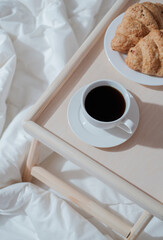 Breakfast on wooden table for bed. Coffee, cake and apple for healthy morning eating. 