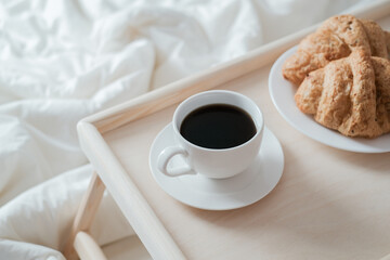 Breakfast on wooden table for bed. Coffee, cake and apple for healthy morning eating. 