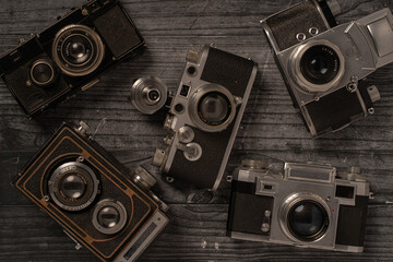 35mm vintage cameras on a dark wood background