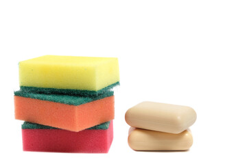 Sponges for washing dishes and two pieces of soap on a white background.